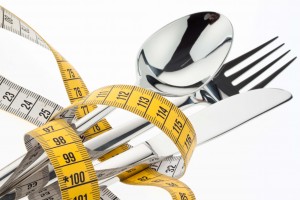 cutlery with tape. symbol for diet and weight loss.
